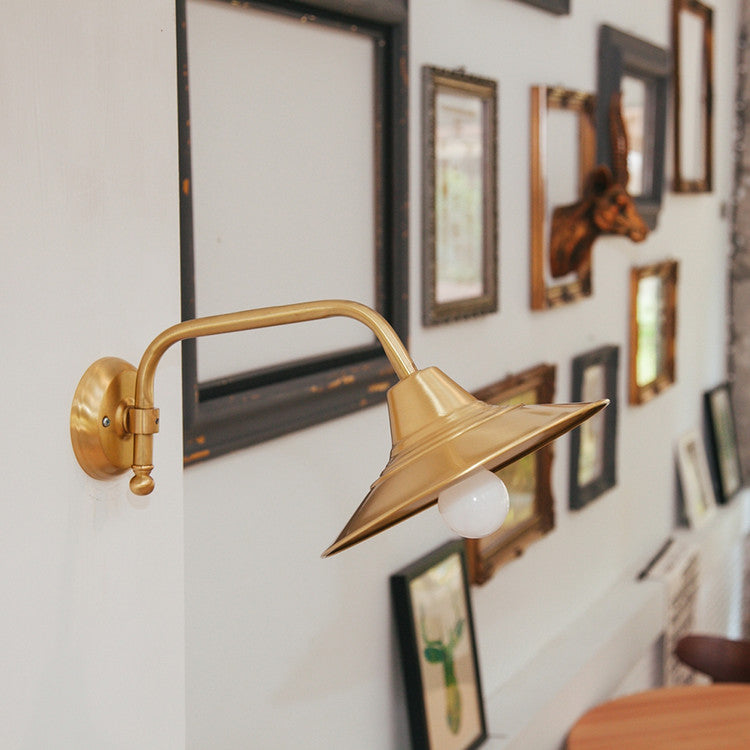 Beveled brass wall light