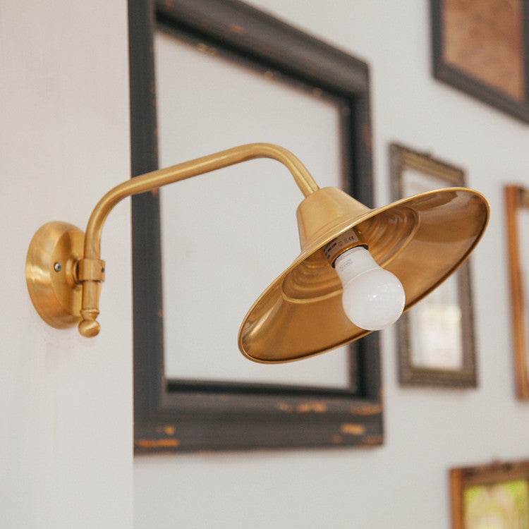 Beveled brass wall light