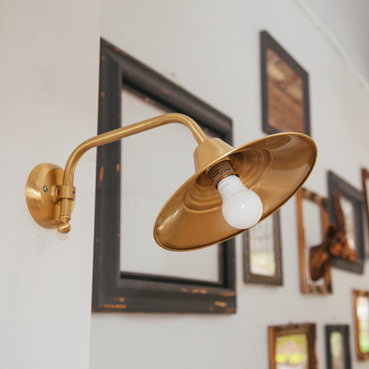 Beveled brass wall light