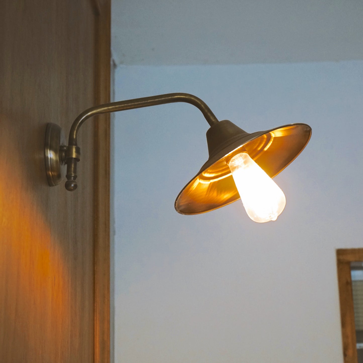 Beveled brass wall light